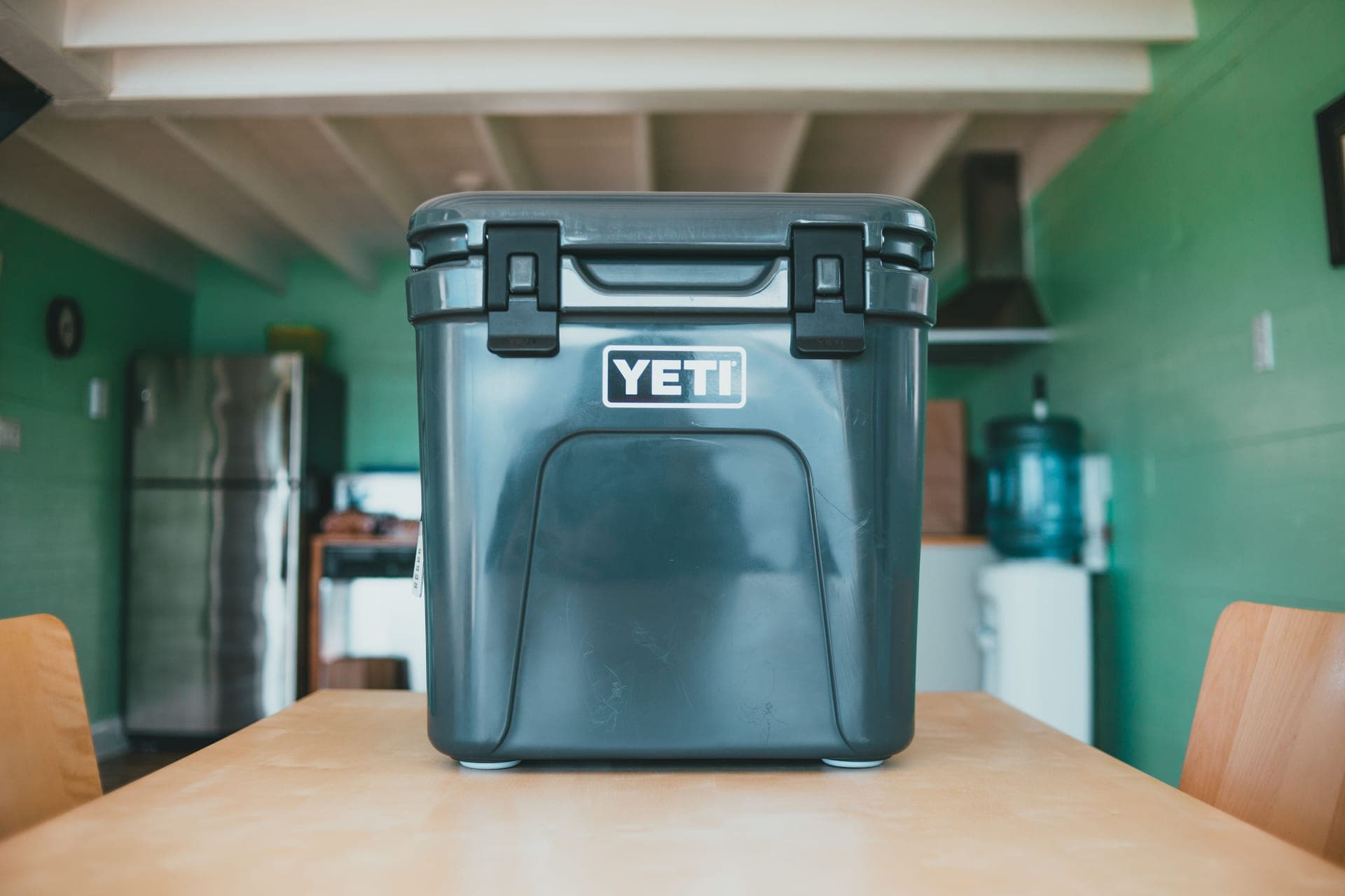 An insulated lunch cooler with a top handle and shoulder strap