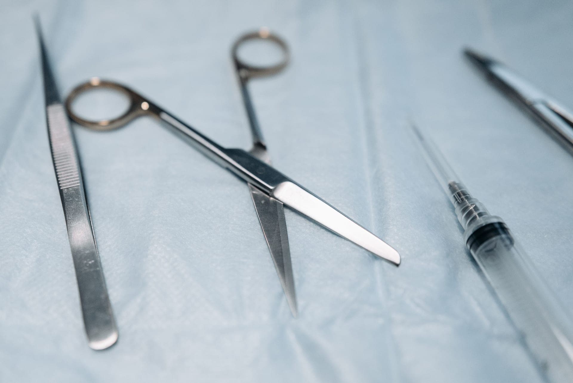 A pair of black-coated trauma shears with a blunt curved tip